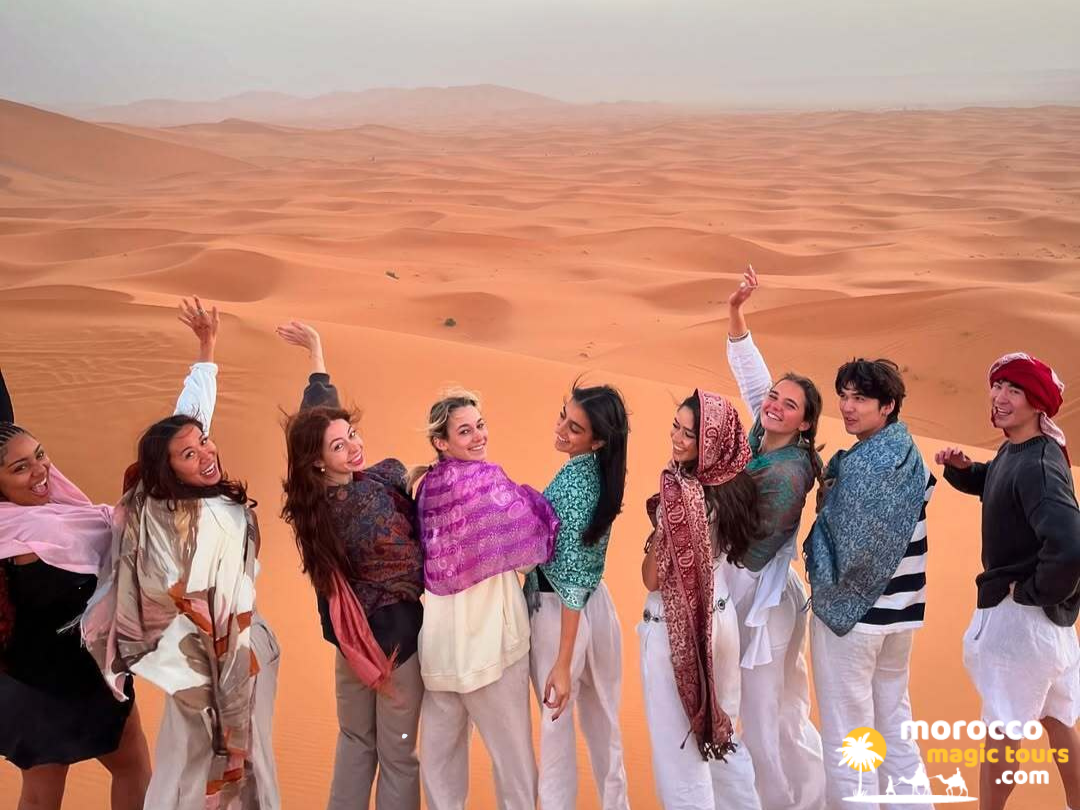 4 days tour from fes to marrakech group students in dunes
