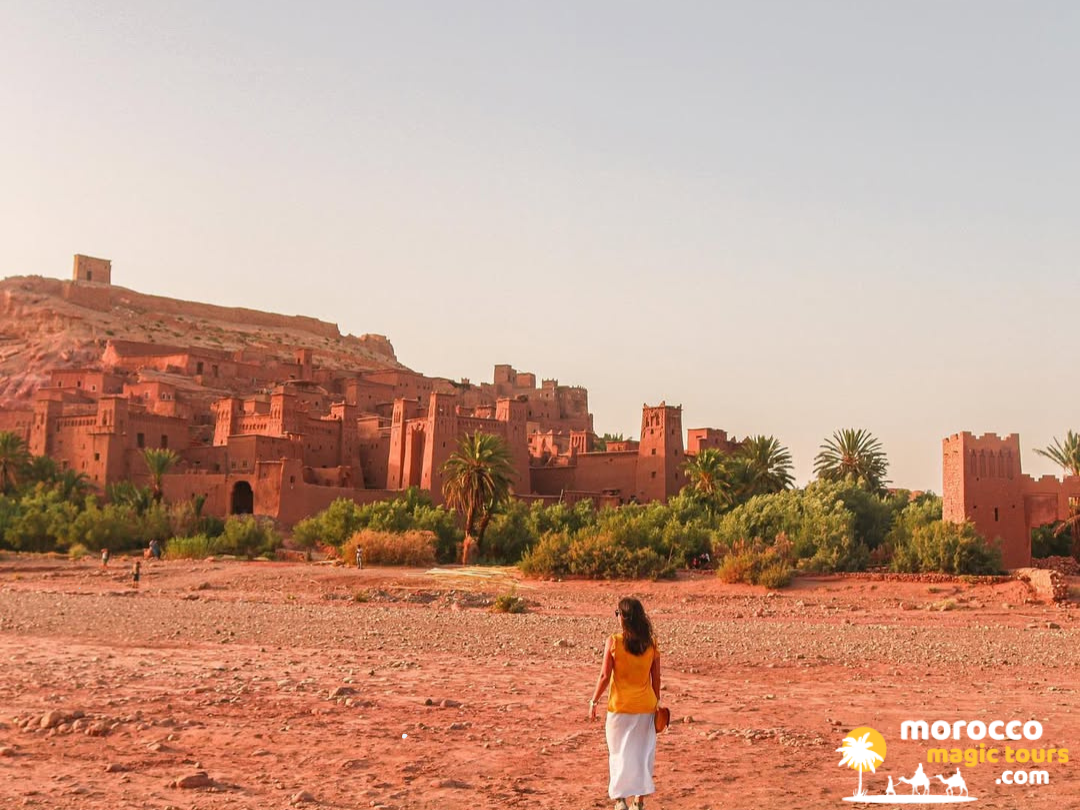 A traveler walking toward the famous Ait Benhaddou on our 4 day desert tour from marrakech