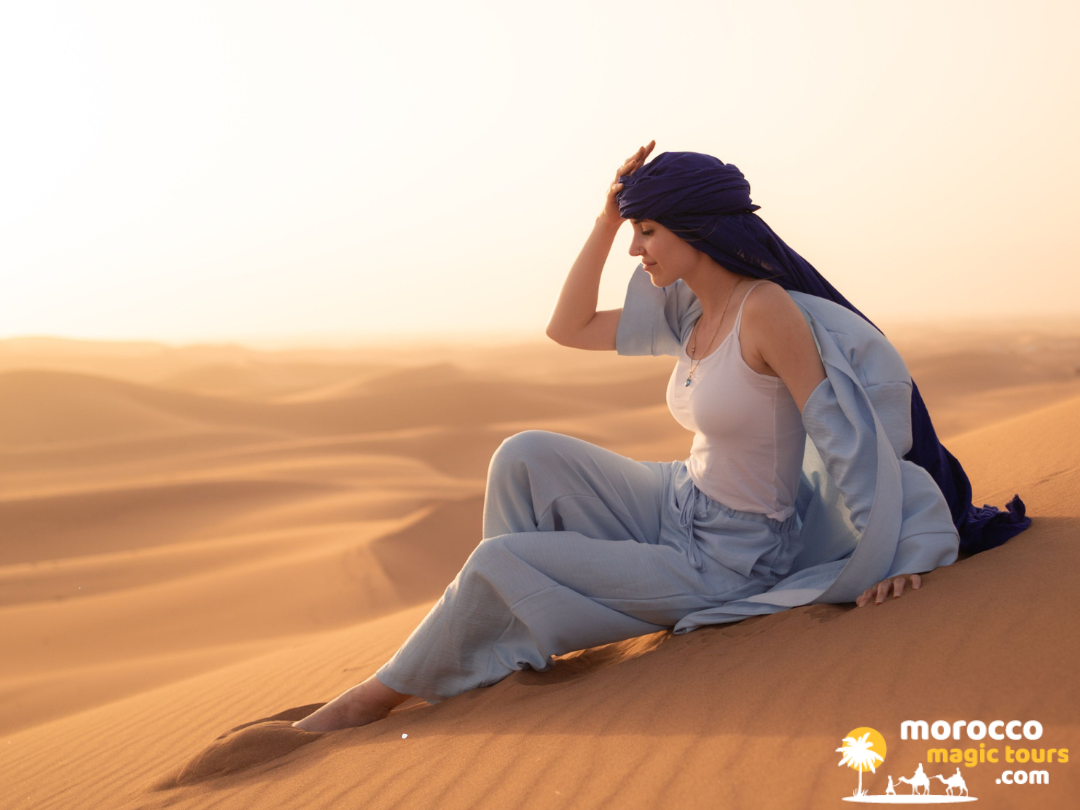 fes desert tours 4 days woman sitting on sand dune