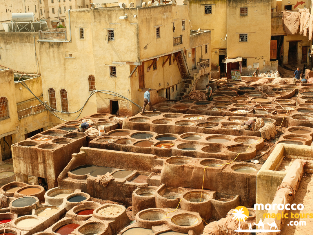The traditional stone dye vats of the ancient Chouara Tannery in the medieval medina of Fes, seen during a morocco tour 10 days.