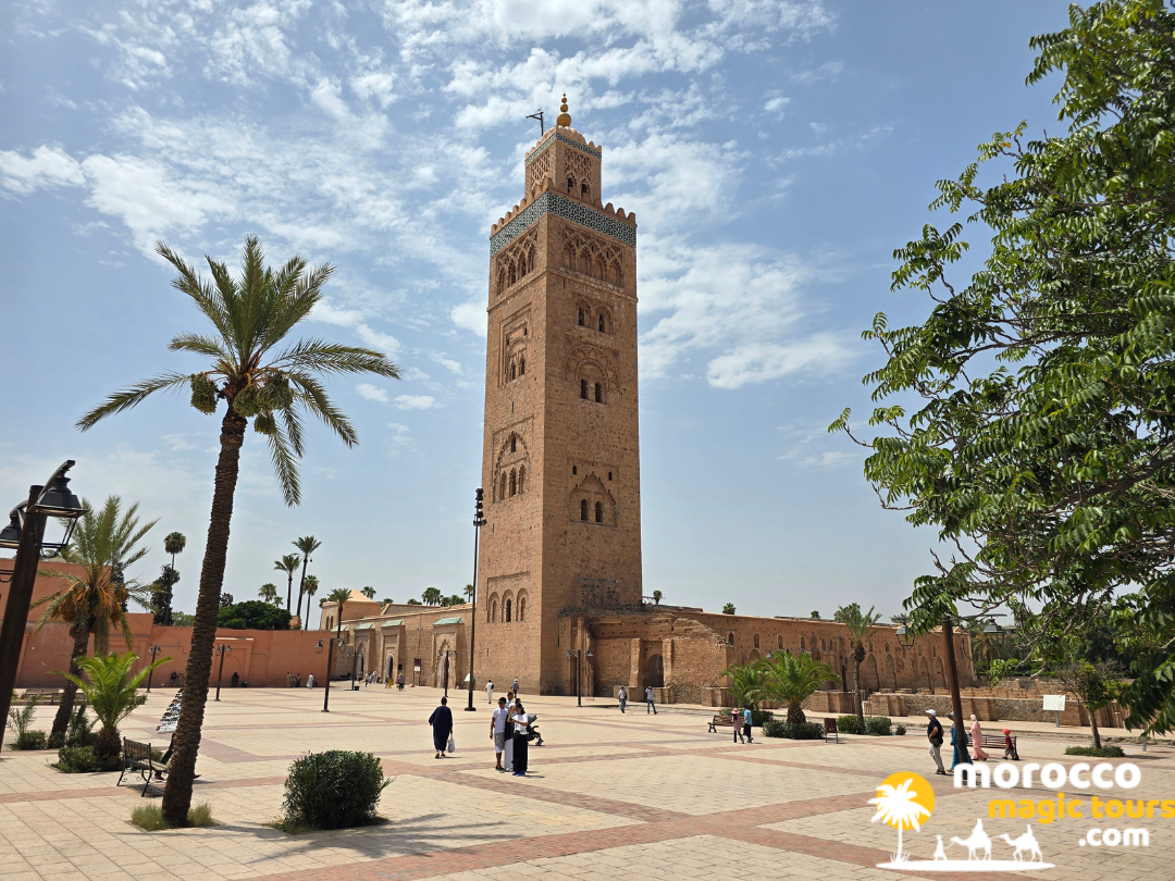 The historic sandstone minaret of the Koutoubia Mosque in Marrakech under a blue sky, a main stop on a 10 day morocco tour.