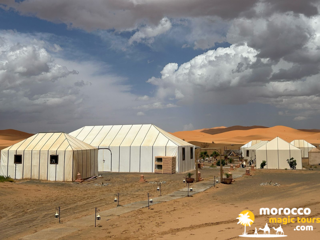 Luxury white desert tents at an authentic Saharan camp, featured on a 10 days desert tour from Casablanca.