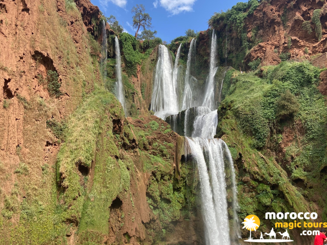 Cascading Ouzoud Waterfalls surrounded by green cliff vegetation on 9 day morocco itinerary