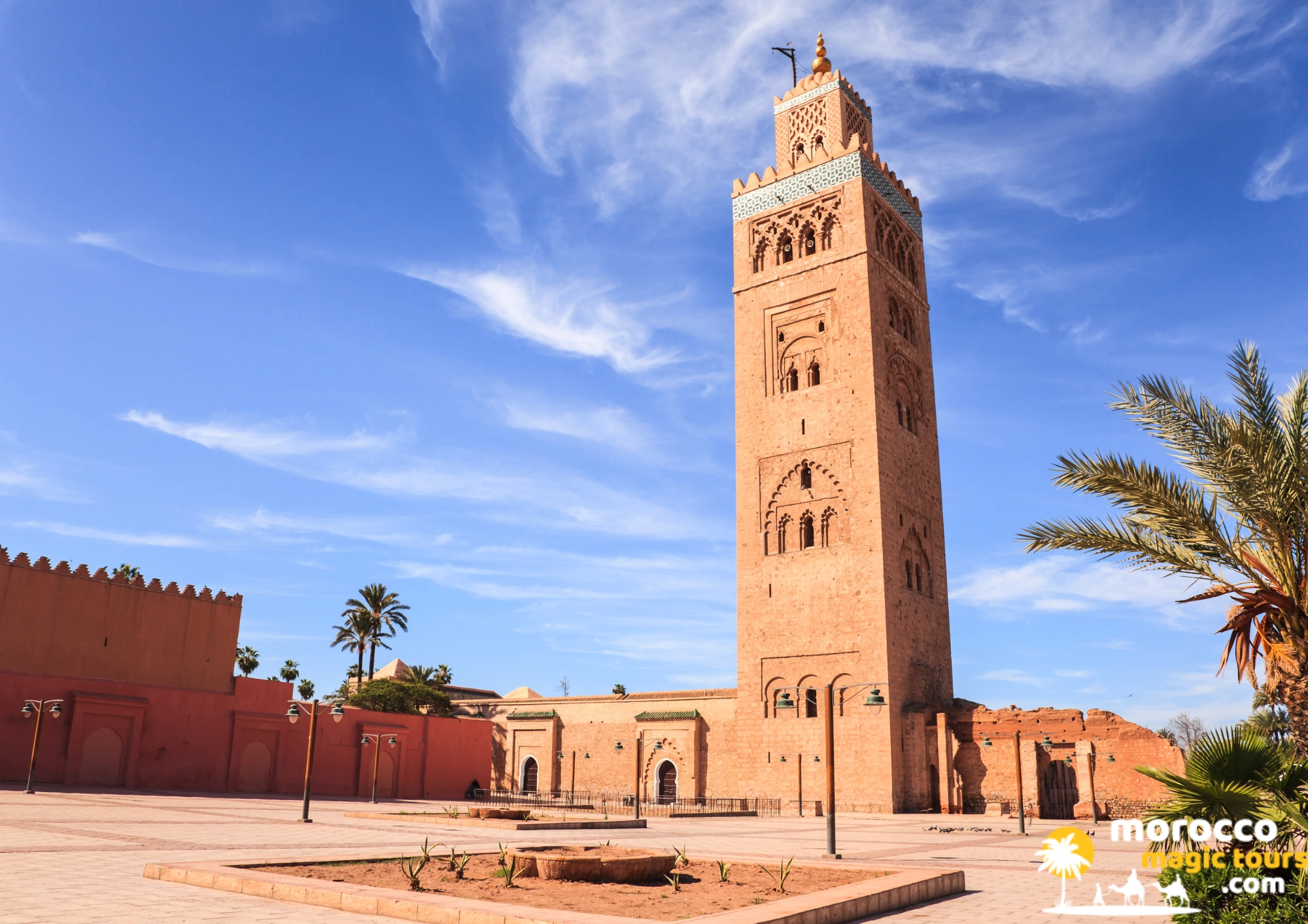 8 days tour from Casablanca the magnificent Koutoubia Mosque minaret against a blue sky with wispy clouds.