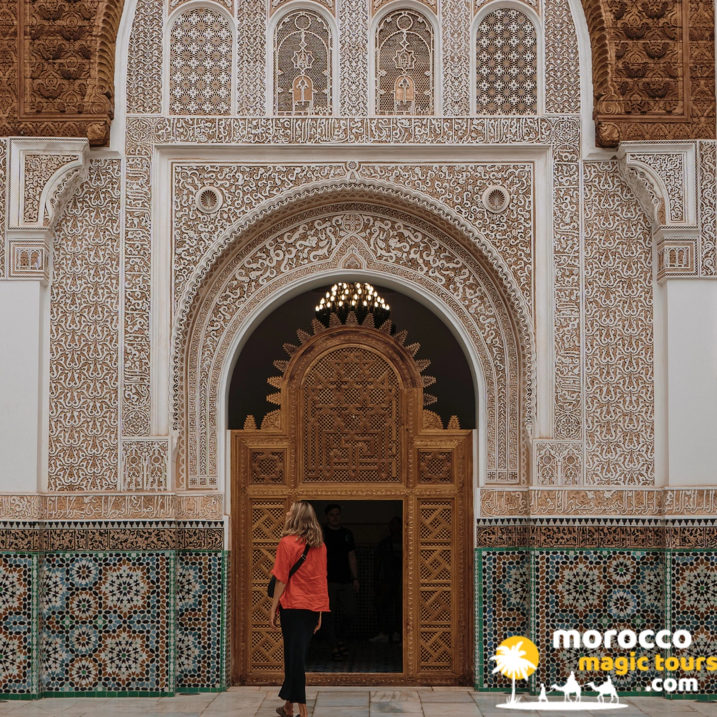 Ornately carved stucco archway at a historic medersa in Fes, visited on the marrakech desert tour 12 days