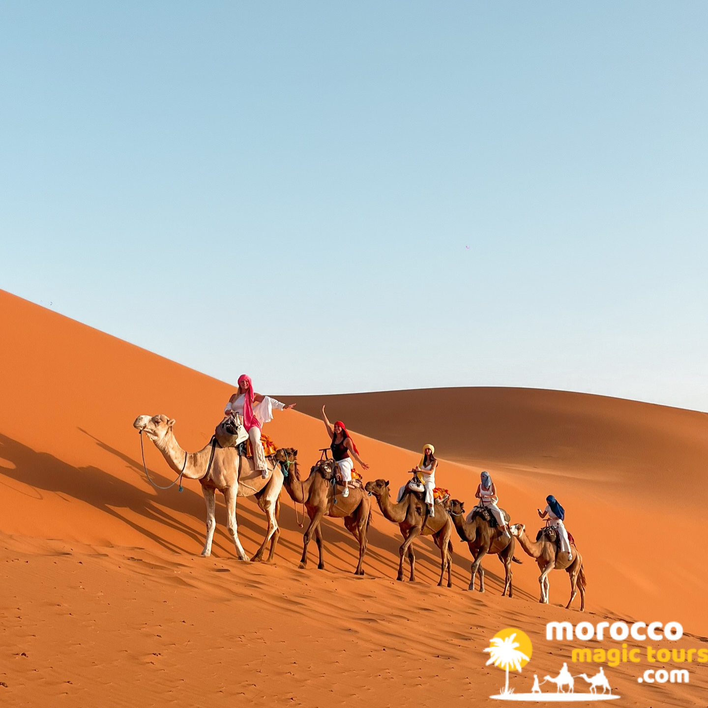 Traveler on a camel at sunset in the Merzouga dunes, marrakech desert tour 12 days