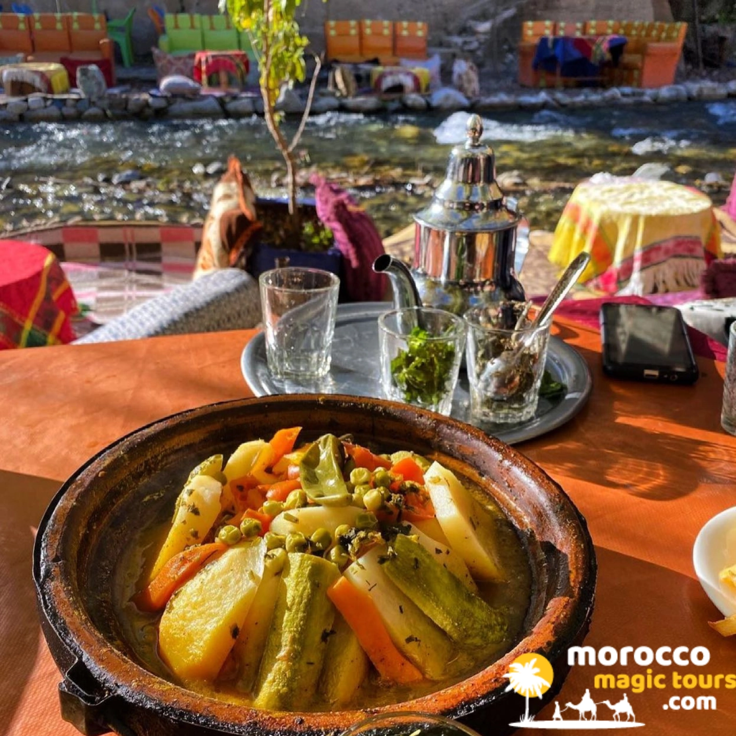 Moroccan vegetable tagine and mint tea served riverside on an Ourika Valley day trip from Marrakech